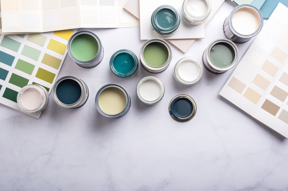 There are many different colors of paint on the table.