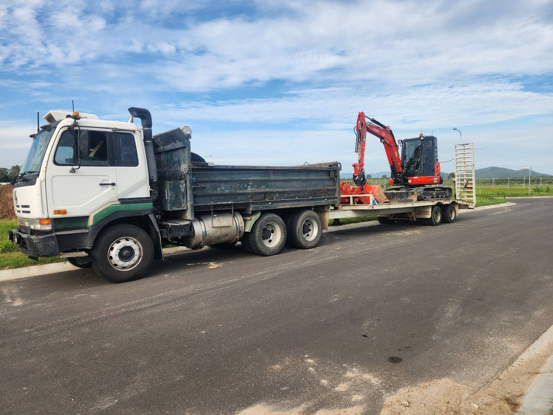 White Dump Truck Towing a Trailer — AGM HIRE NQ in Kelso, QLD