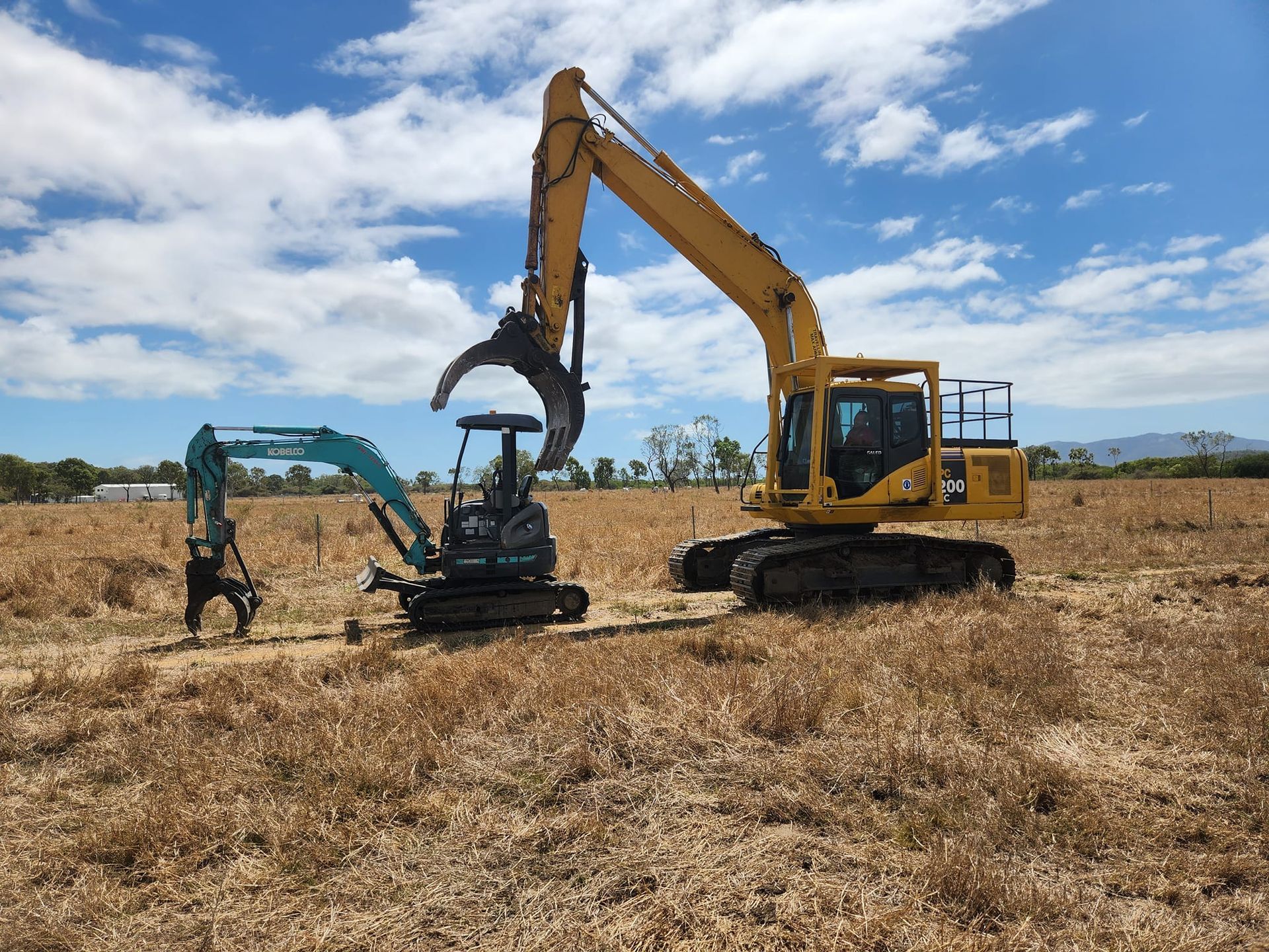 Two Excavators in a Dry Field — AGM HIRE NQ in Kirwan, QLD