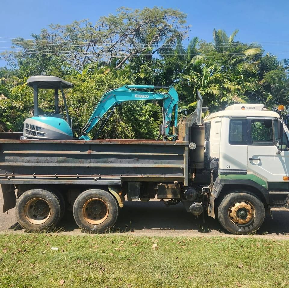 A Light-blue Mini Excavator Loaded in the Back of a Dump Truck — AGM HIRE NQ in Kelso, QLD