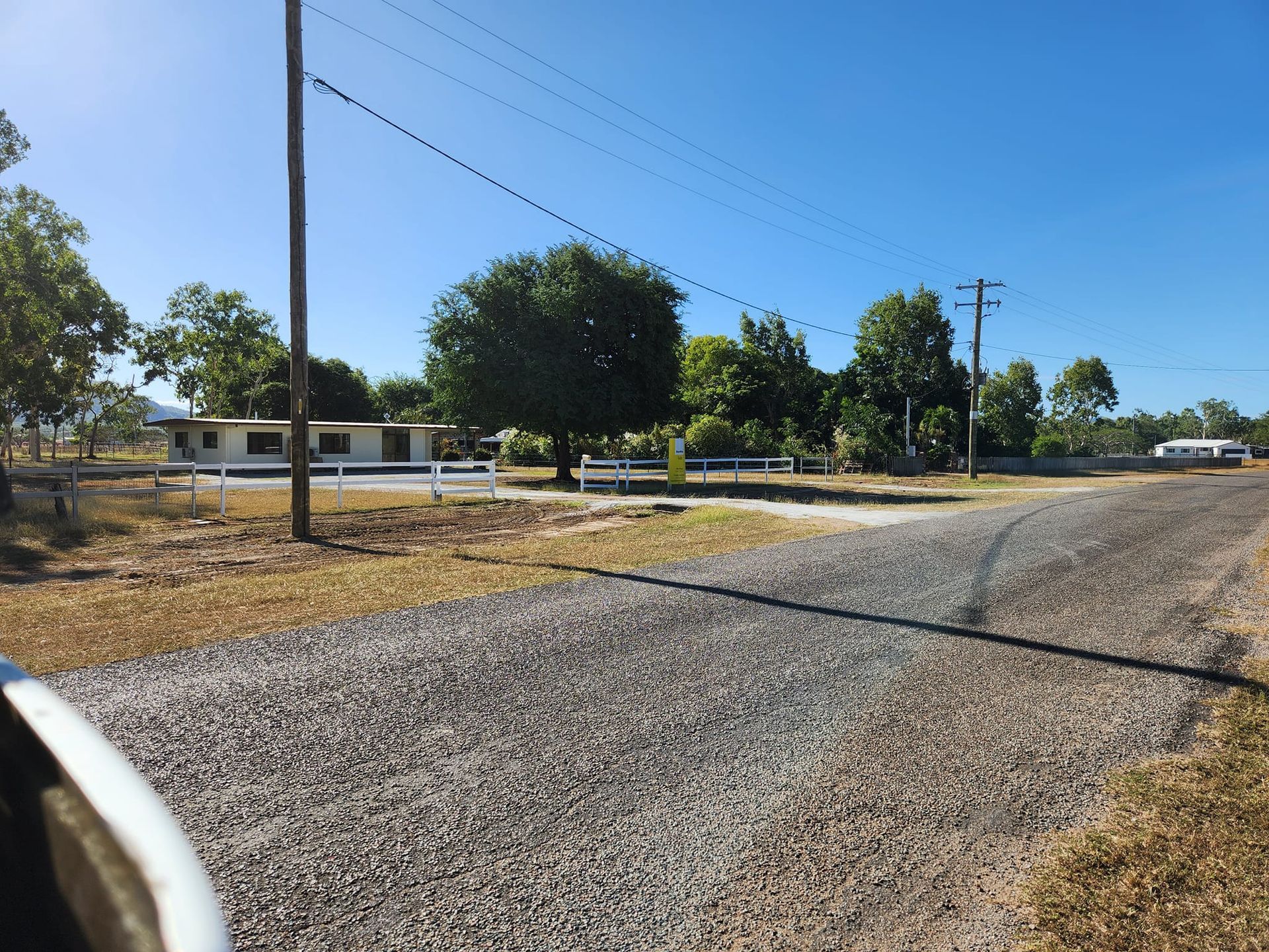 Gravel Road Leading to a Small White Building — AGM HIRE NQ in Kirwan, QLD