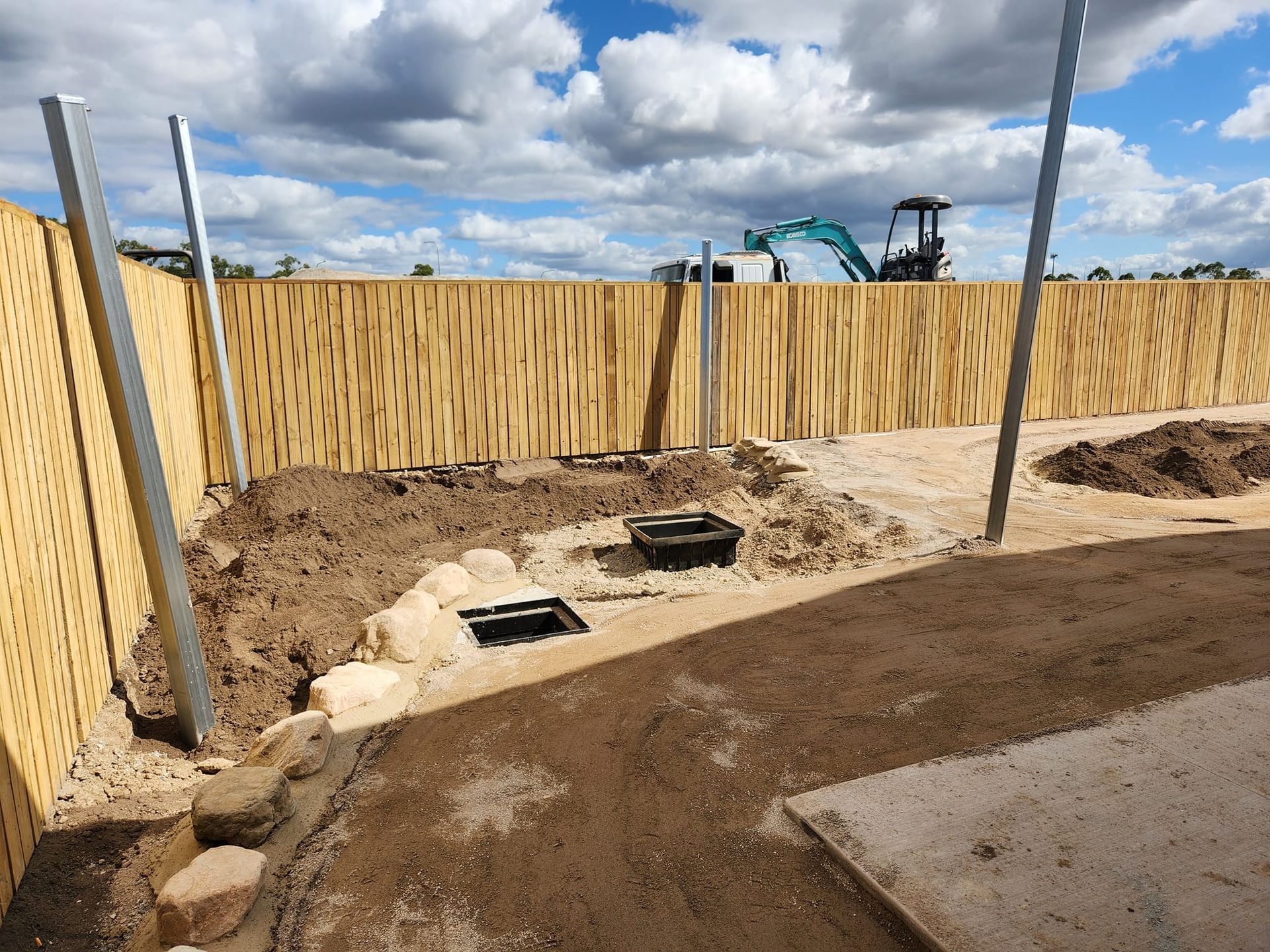Construction Site With Wooden Fence, and Metal Posts — AGM HIRE NQ in Kelso, QLD