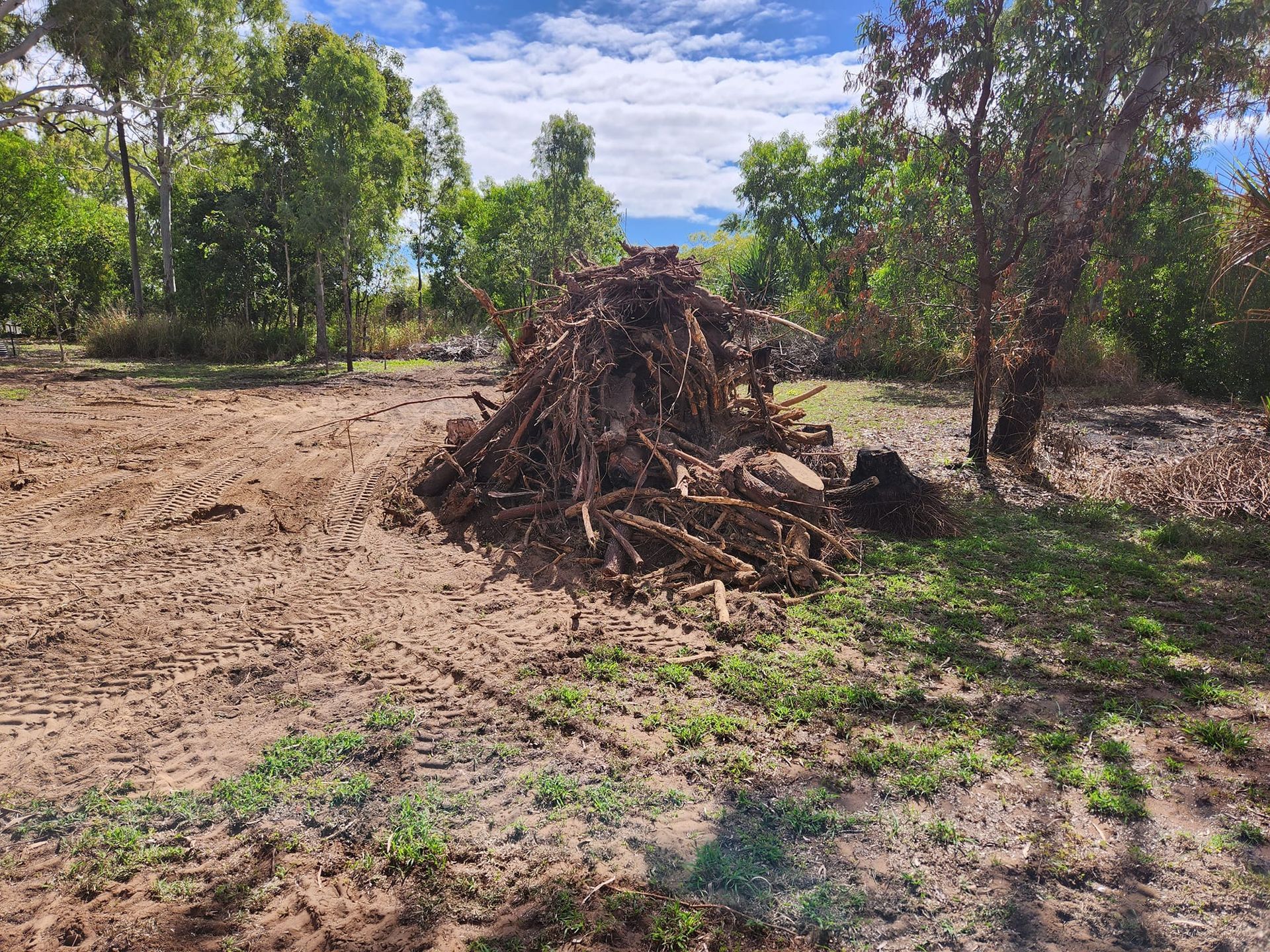 Pile of Brush in a Cleared Field, Trees in the Background — AGM HIRE NQ in Condon, QLD