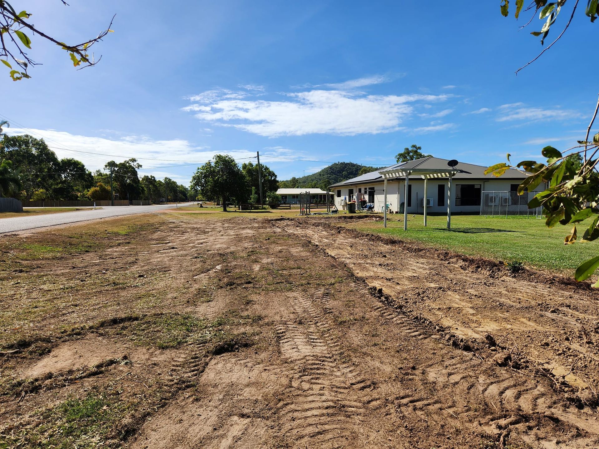 Dirt Path in Front of a House Under Construction; Blue Sky Overhead — AGM HIRE NQ in Condon, QLD