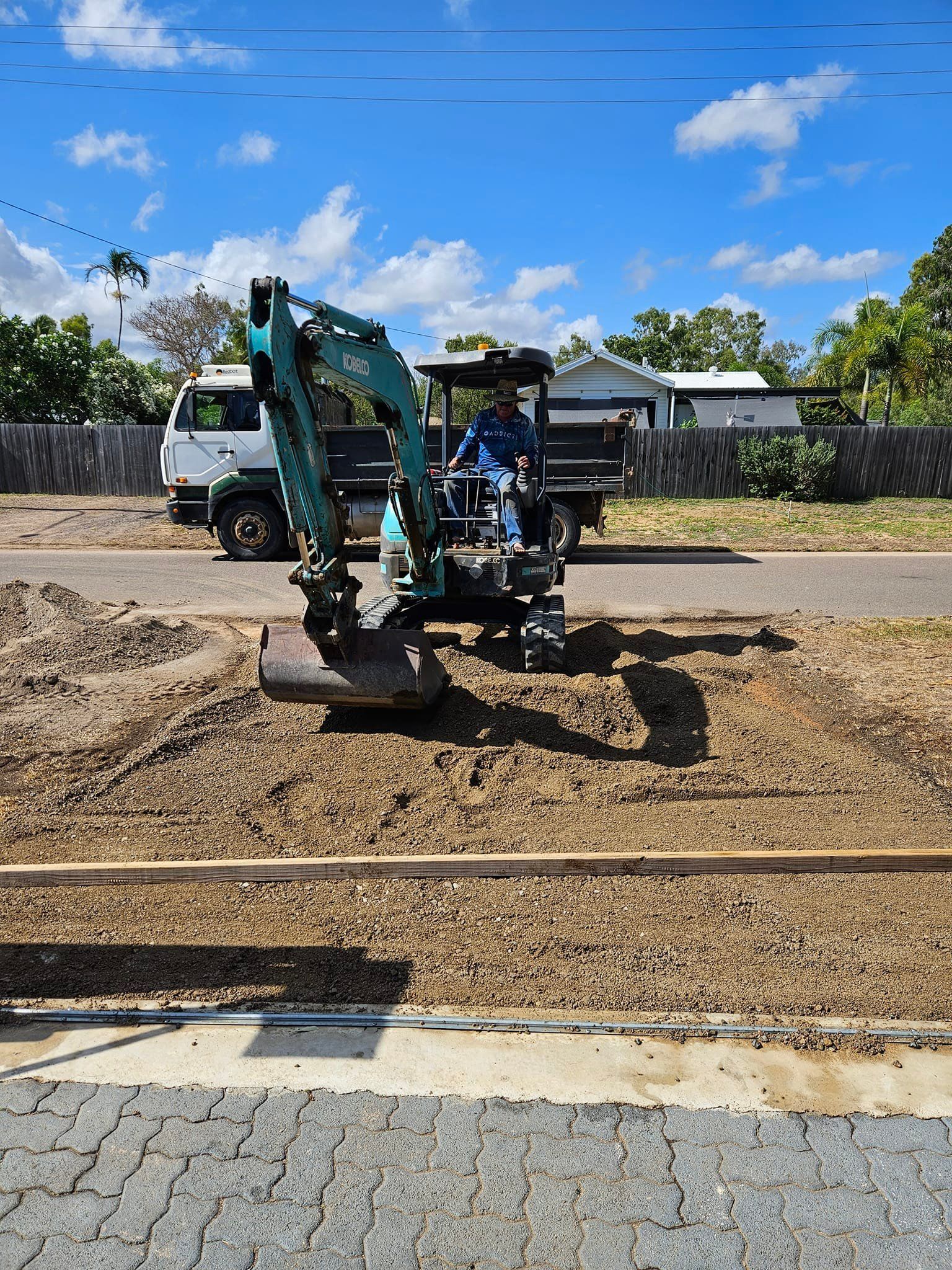 Mini Excavator on Gravel Next to a Street — AGM HIRE NQ in Condon, QLD