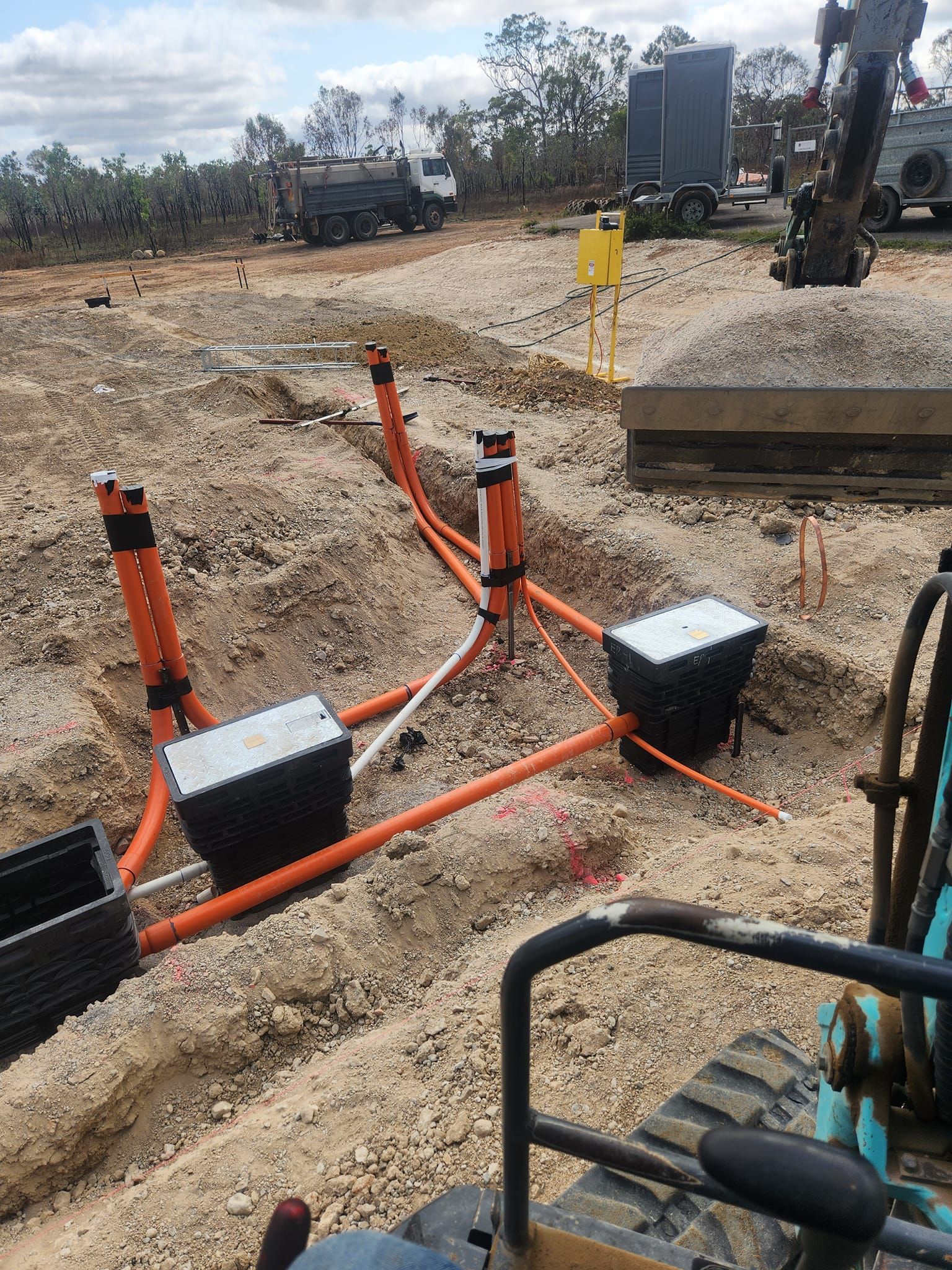 Construction Site With Orange Conduit and Black Boxes — AGM HIRE NQ in Kelso, QLD