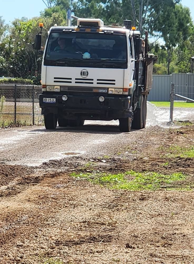 White Truck Driving on a Dirt Road — AGM HIRE NQ in Condon, QLD