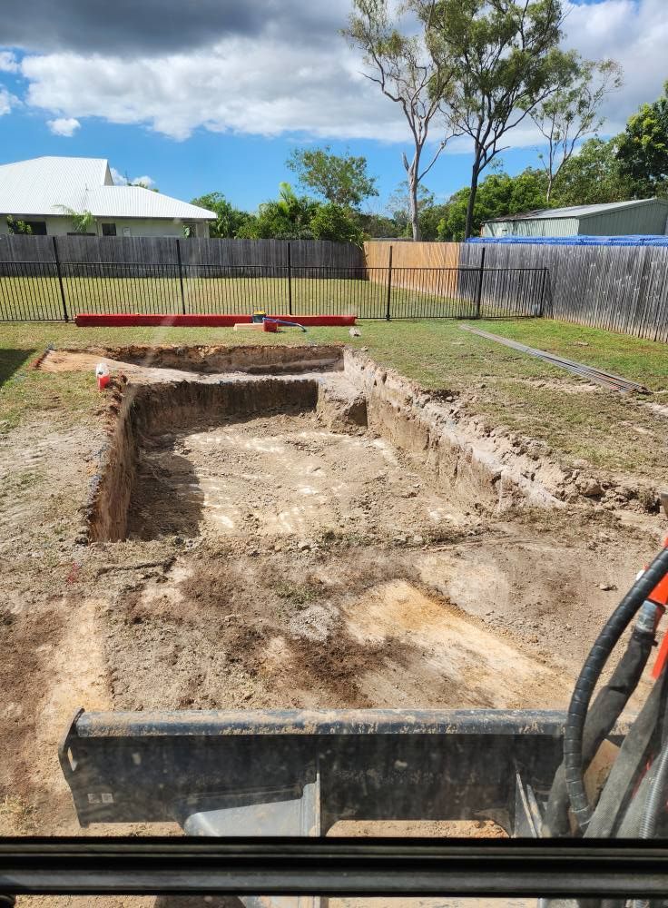 Excavated Foundation of a Building on a Grassy Lot — AGM HIRE NQ in Condon, QLD