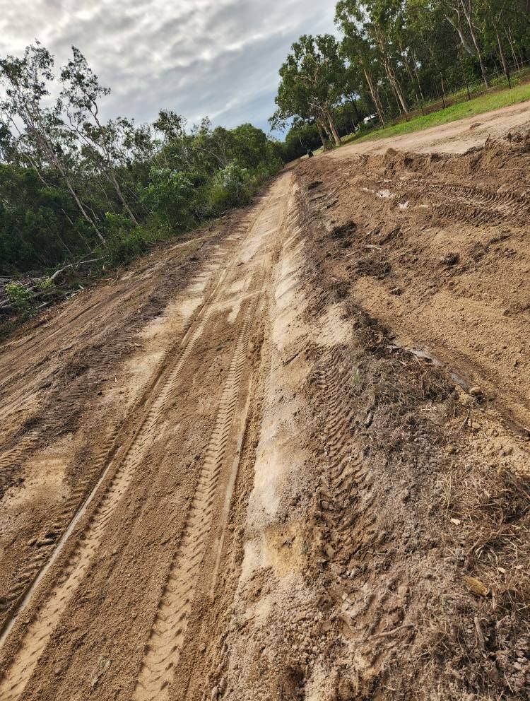 Dirt Road With Tire Tracks, Leading Up a Hill Toward Trees — AGM HIRE NQ in Condon, QLD