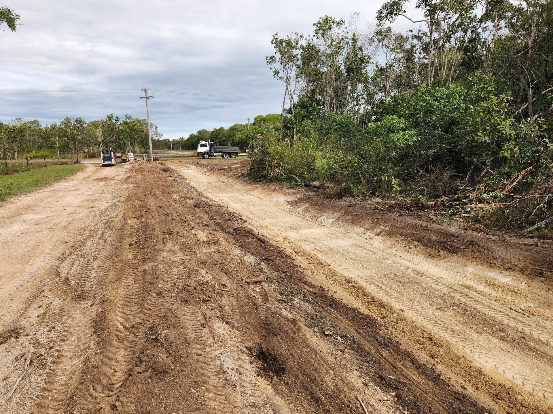 Dirt Road With Tire Tracks, Trees and Overcast Sky — AGM HIRE NQ in Condon, QLD