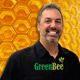 Smiling person wearing a black button-down shirt with a 