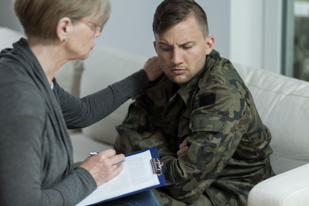 A Therapist Places a Hand on the Shoulder of a Soldier in Uniform — Bright Day Psychology in Pialba, QLD