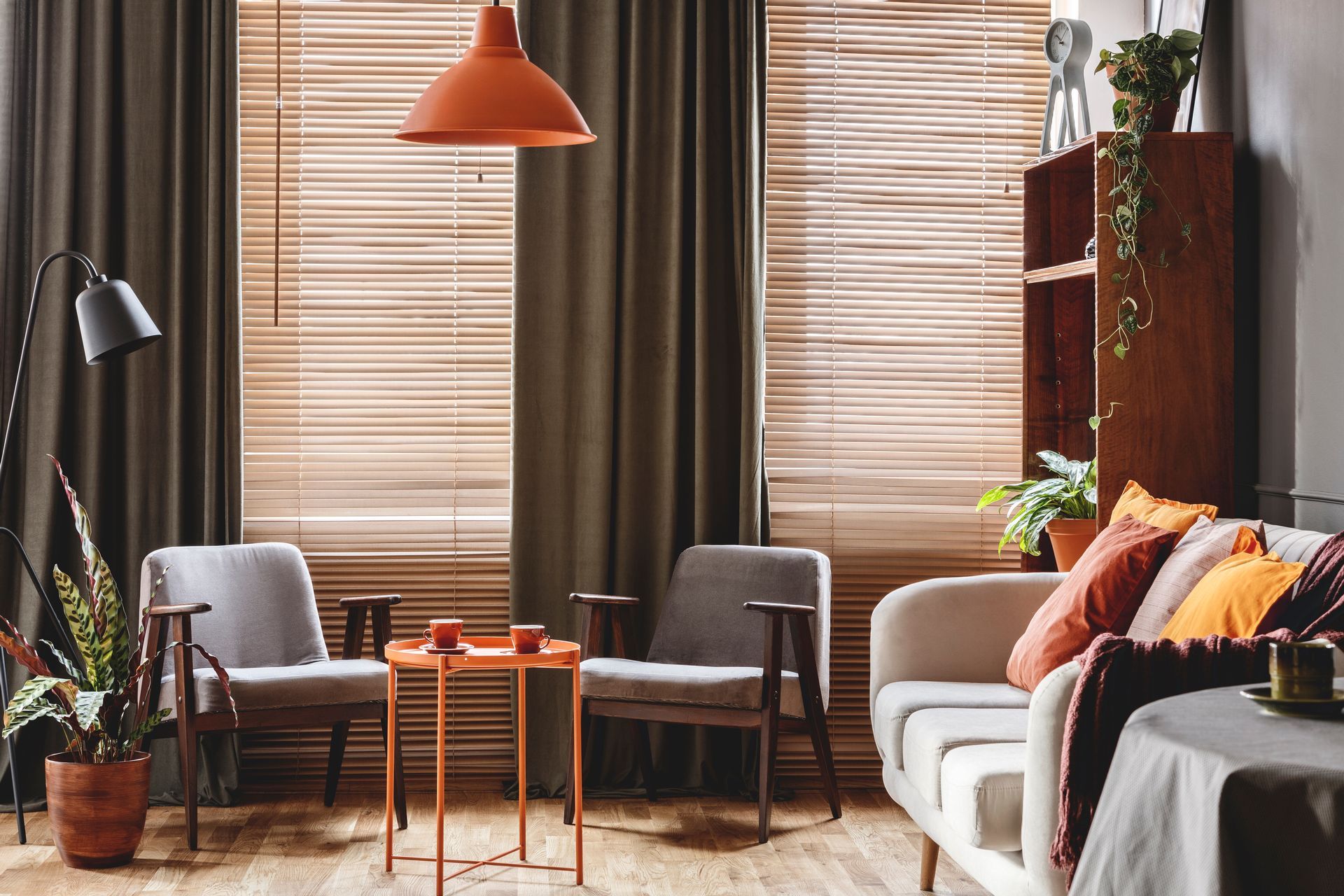 A retro living room interior with dark drapes.