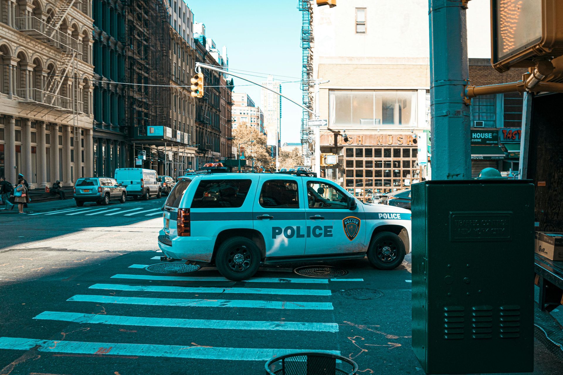 A police car is parked on the side of a city street.