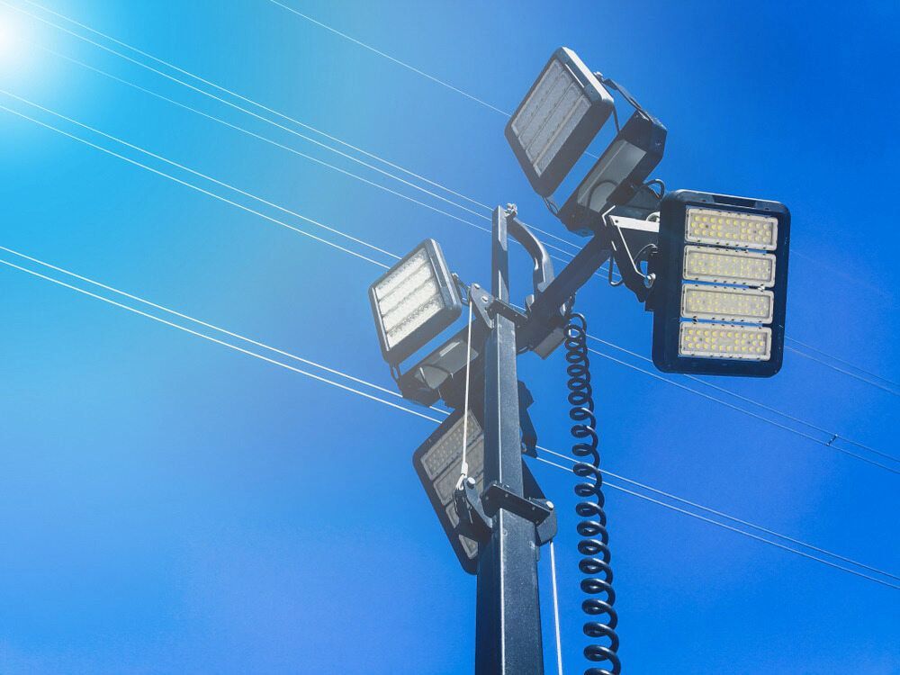 A Tower With a Lot of Lights on It Against a Blue Sky — One Group Industries Pty Ltd in Bathurst, NSW