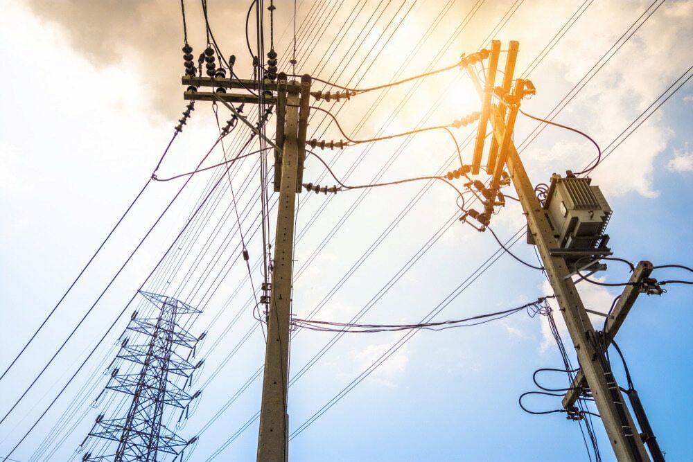 Looking Up at a Bunch of Power Lines Against a Blue Sky — One Group Industries Pty Ltd in Bathurst, NSW