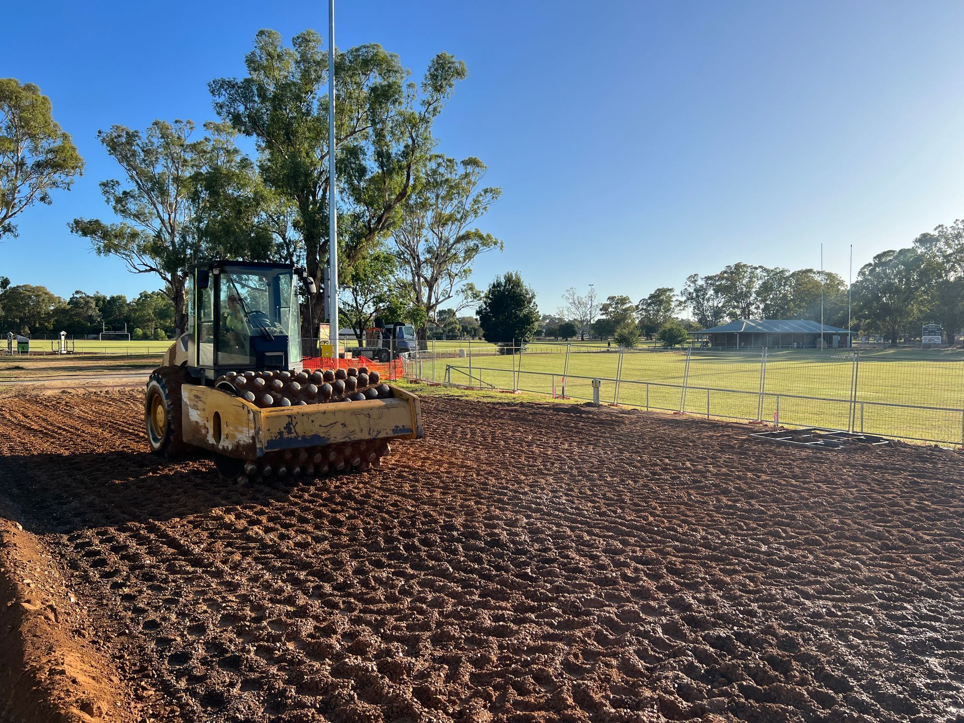 A Bulldozer is Moving Dirt in a Field — One Group Industries Pty Ltd in Bathurst, NSW