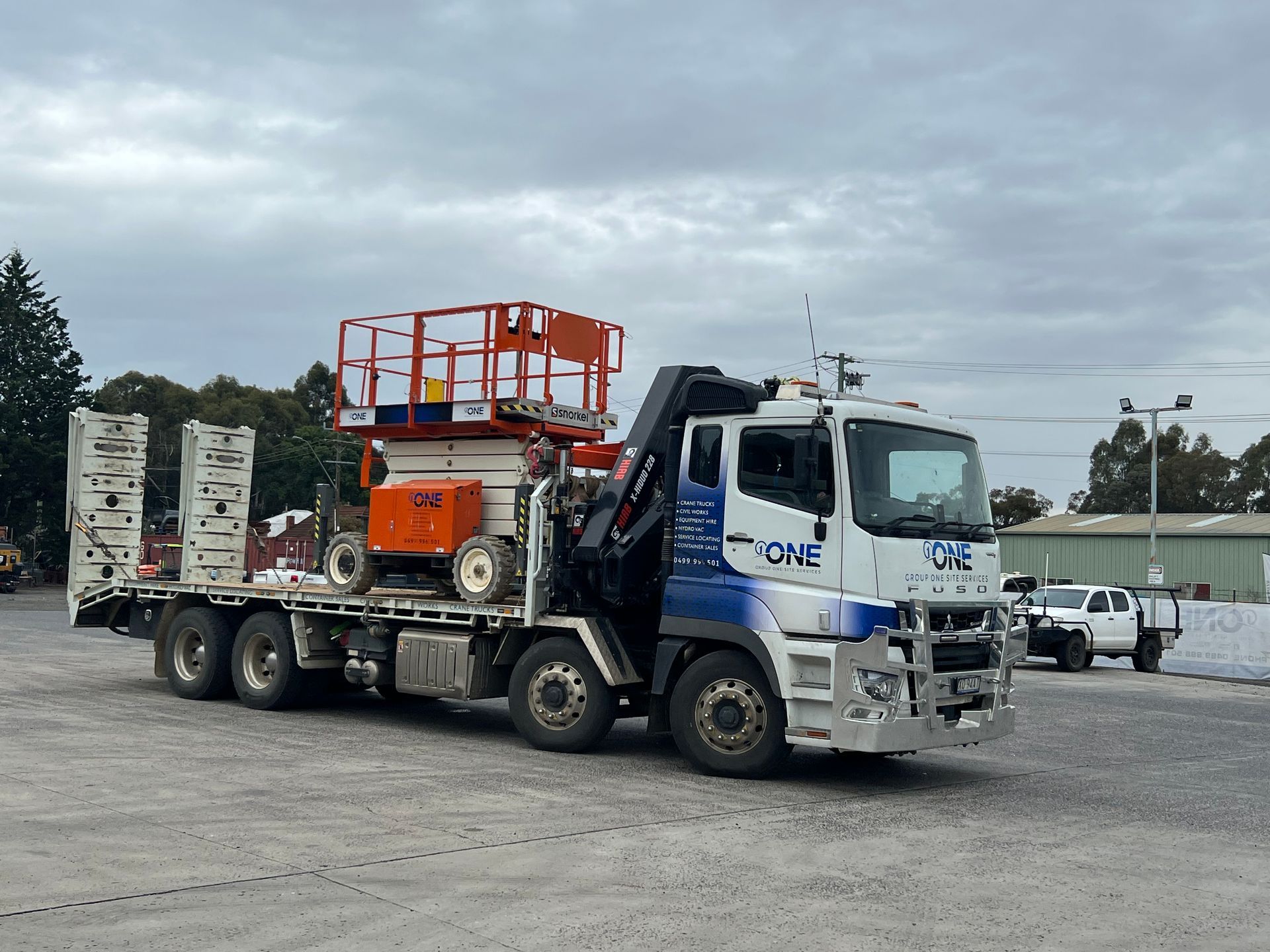 A Truck With a Lift on the Back of It is Parked in a Parking Lot — One Group Industries Pty Ltd in Bathurst, NSW