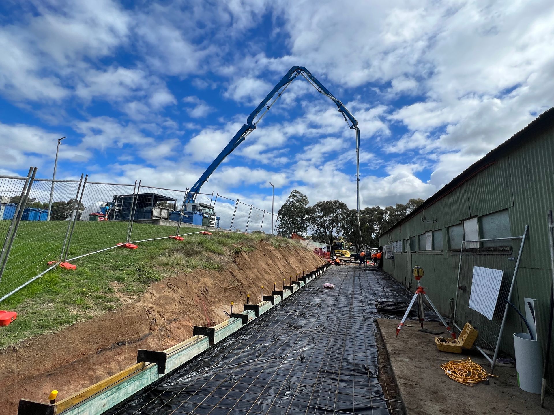 A Concrete Pump is Being Used to Pour Concrete on a Construction Site — One Group Industries Pty Ltd in Bathurst, NSW