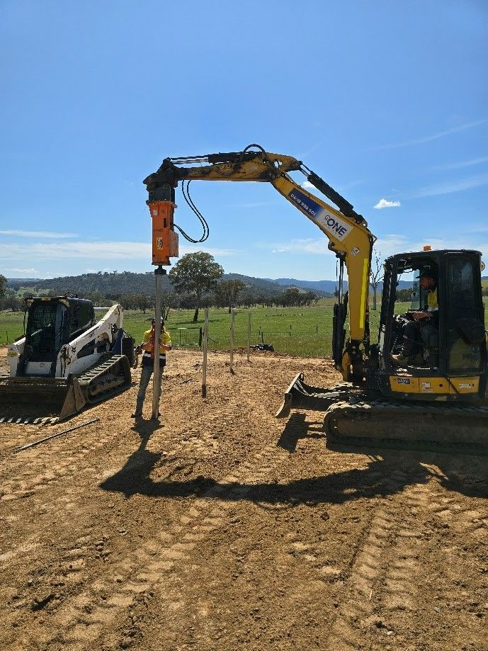 An Excavator Uses a Jackhammer Attachment to Work on Posts in A Field — One Group Industries Pty Ltd in Bathurst, NSW