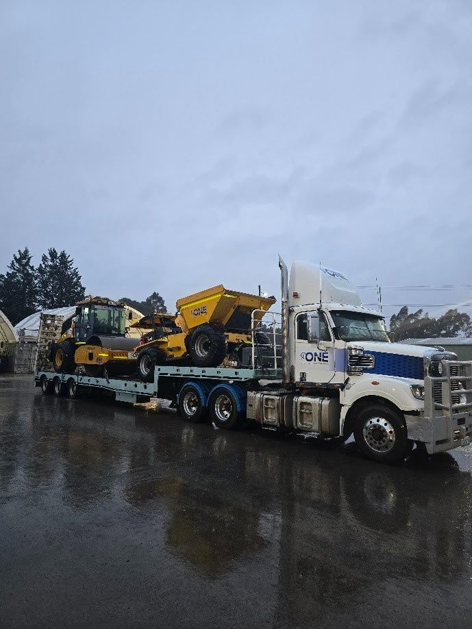 Truck Transporting Construction Equipment on A Rainy Day — One Group Industries Pty Ltd in Bathurst, NSW