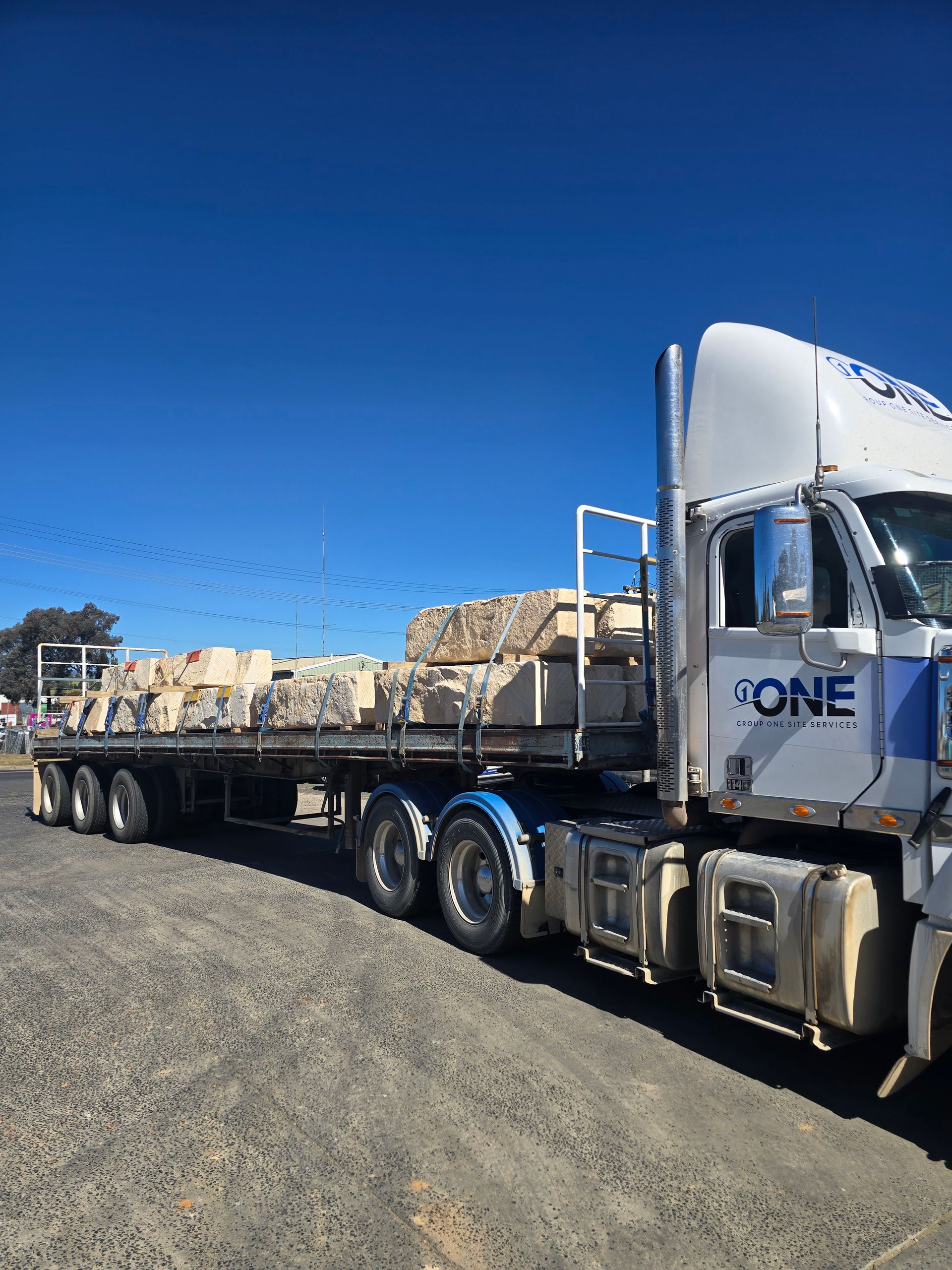 A White Flatbed Truck Parked on A Grassy Area — One Group Industries Pty Ltd in Bathurst, NSW