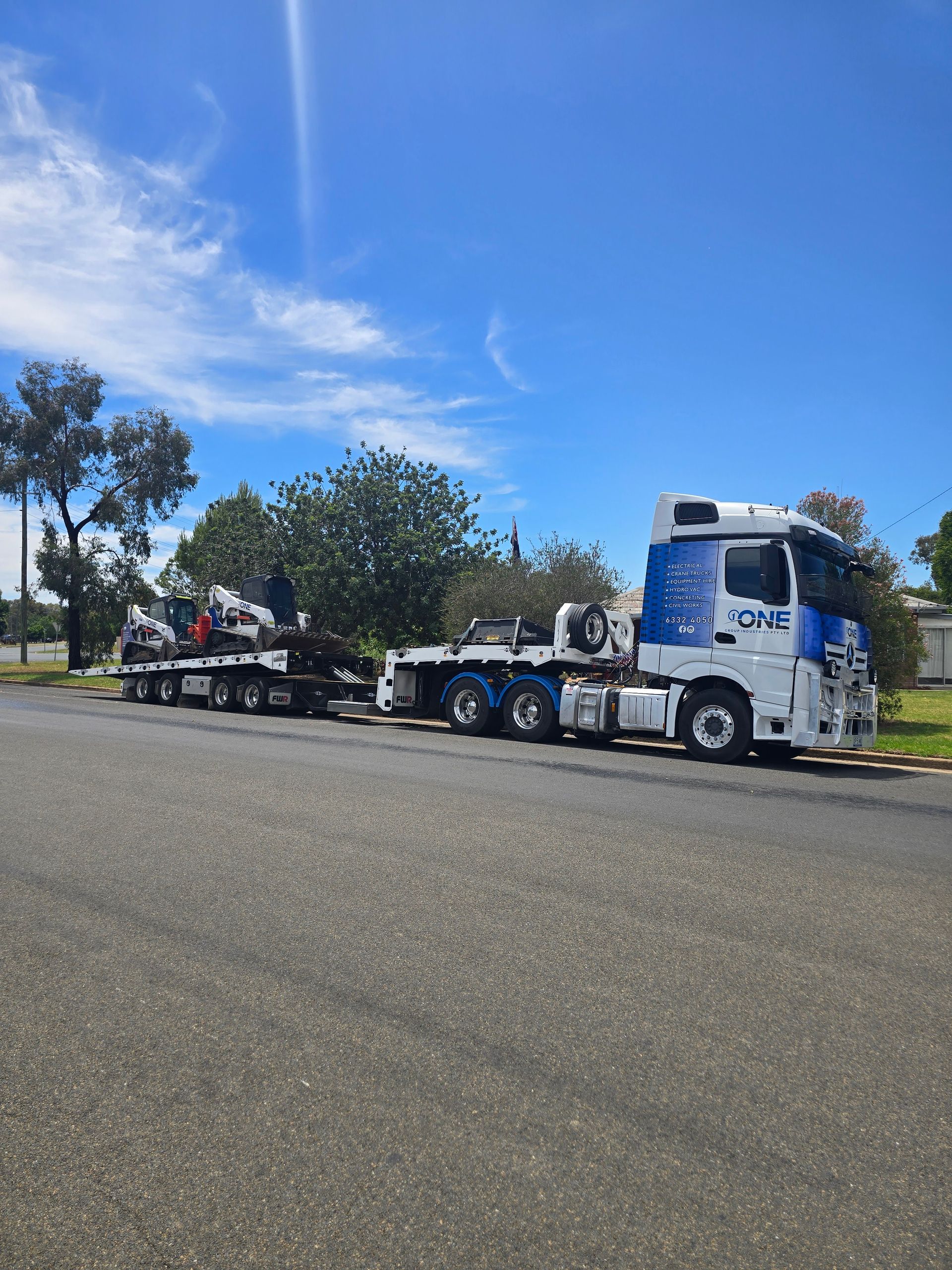 A White and Blue Flatbed Truck with A Mounted Crane — One Group Industries Pty Ltd in Bathurst, NSW