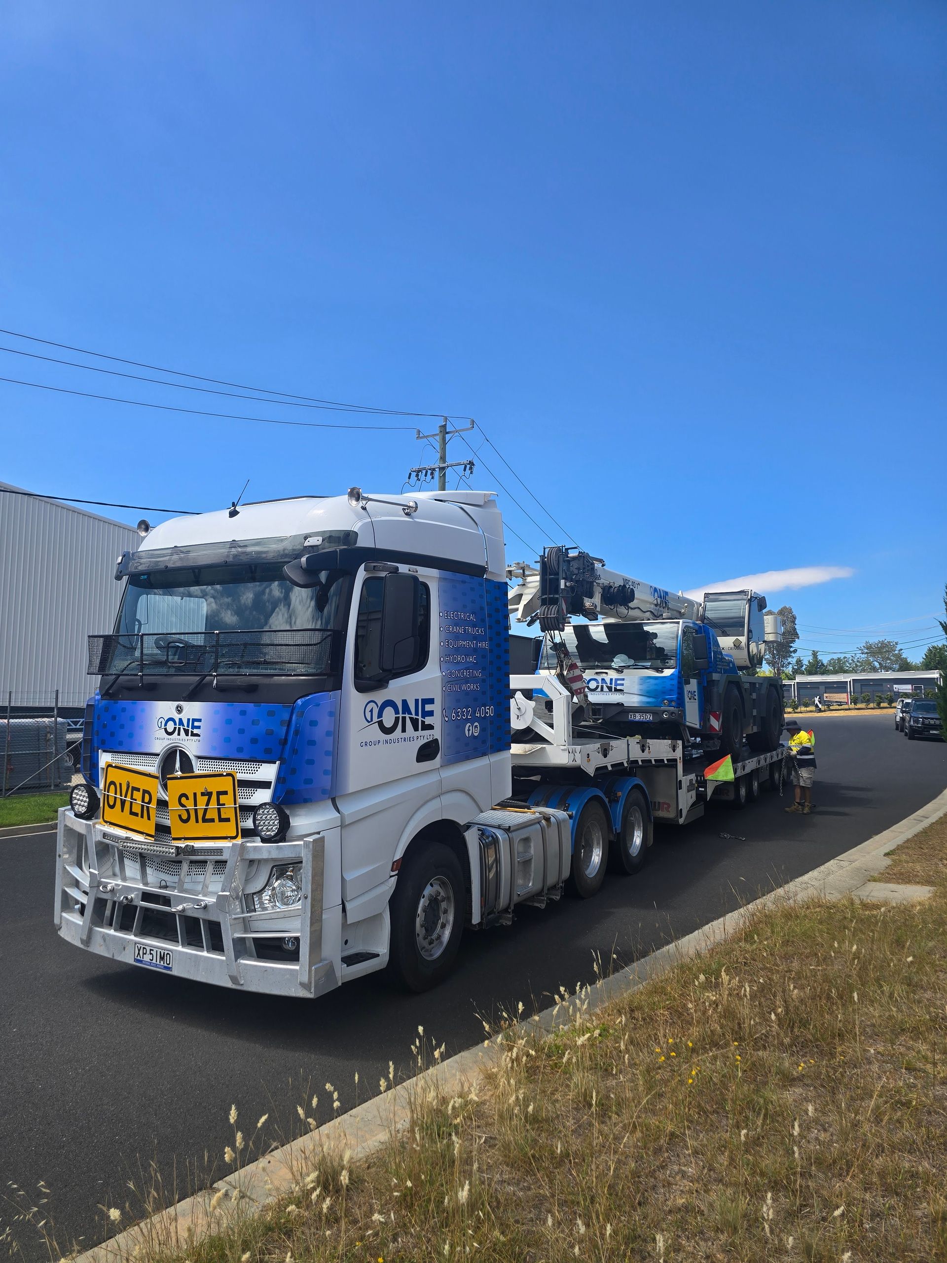 A White Fuso Truck with Branding Parked on A Grassy Field — One Group Industries Pty Ltd in Bathurst, NSW