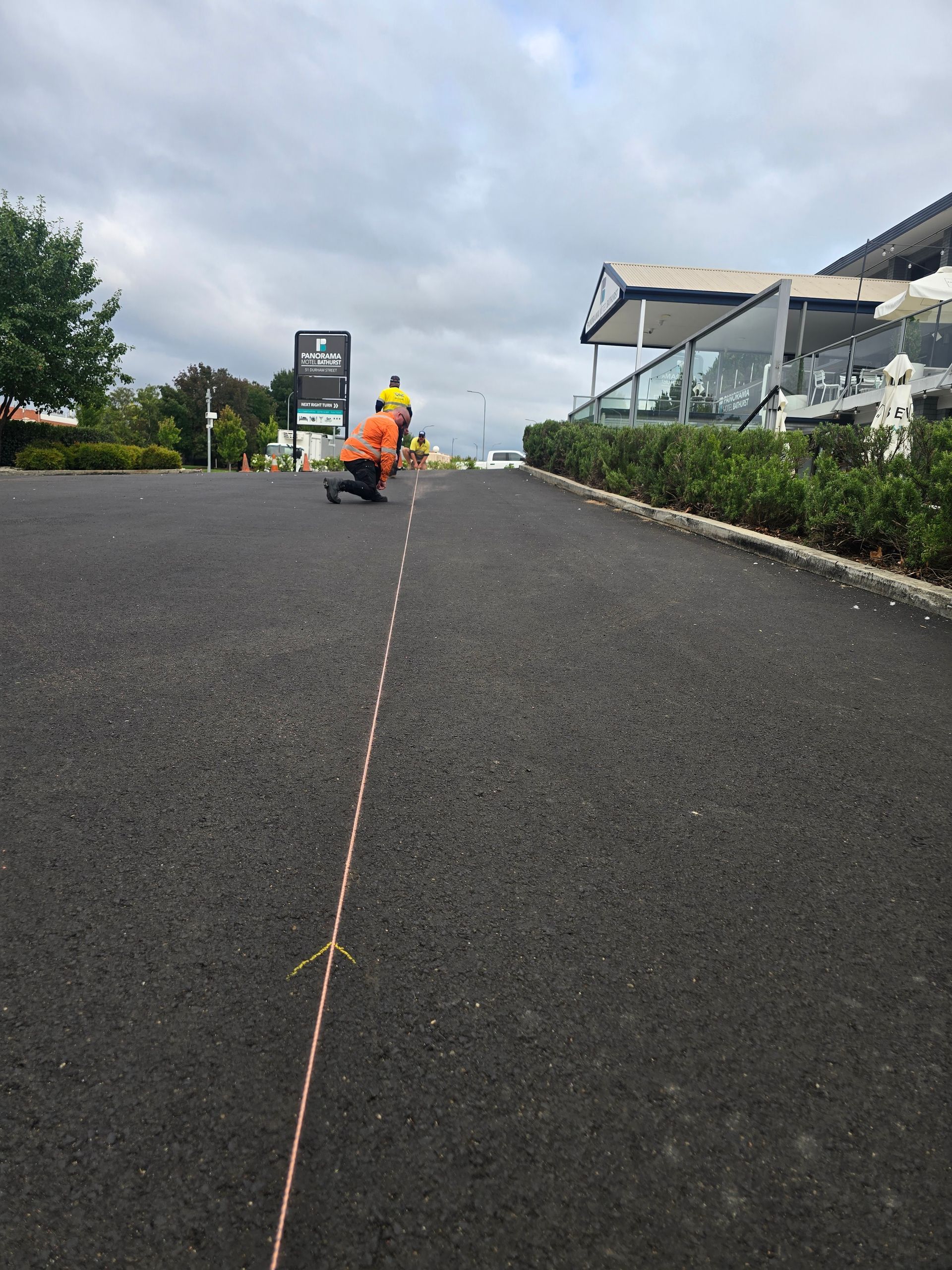 Workers in High-Visibility Clothing Operate Road Paving Machinery — One Group Industries Pty Ltd in Bathurst, NSW