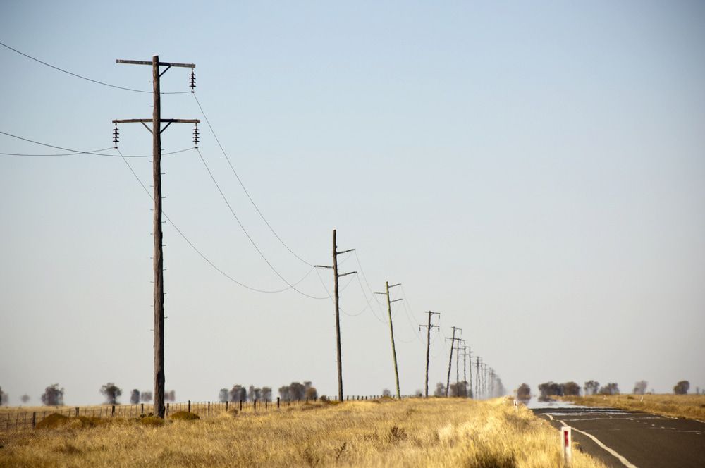 A Row of Power Lines Along the Side of a Road — One Group Industries Pty Ltd in Bathurst, NSW