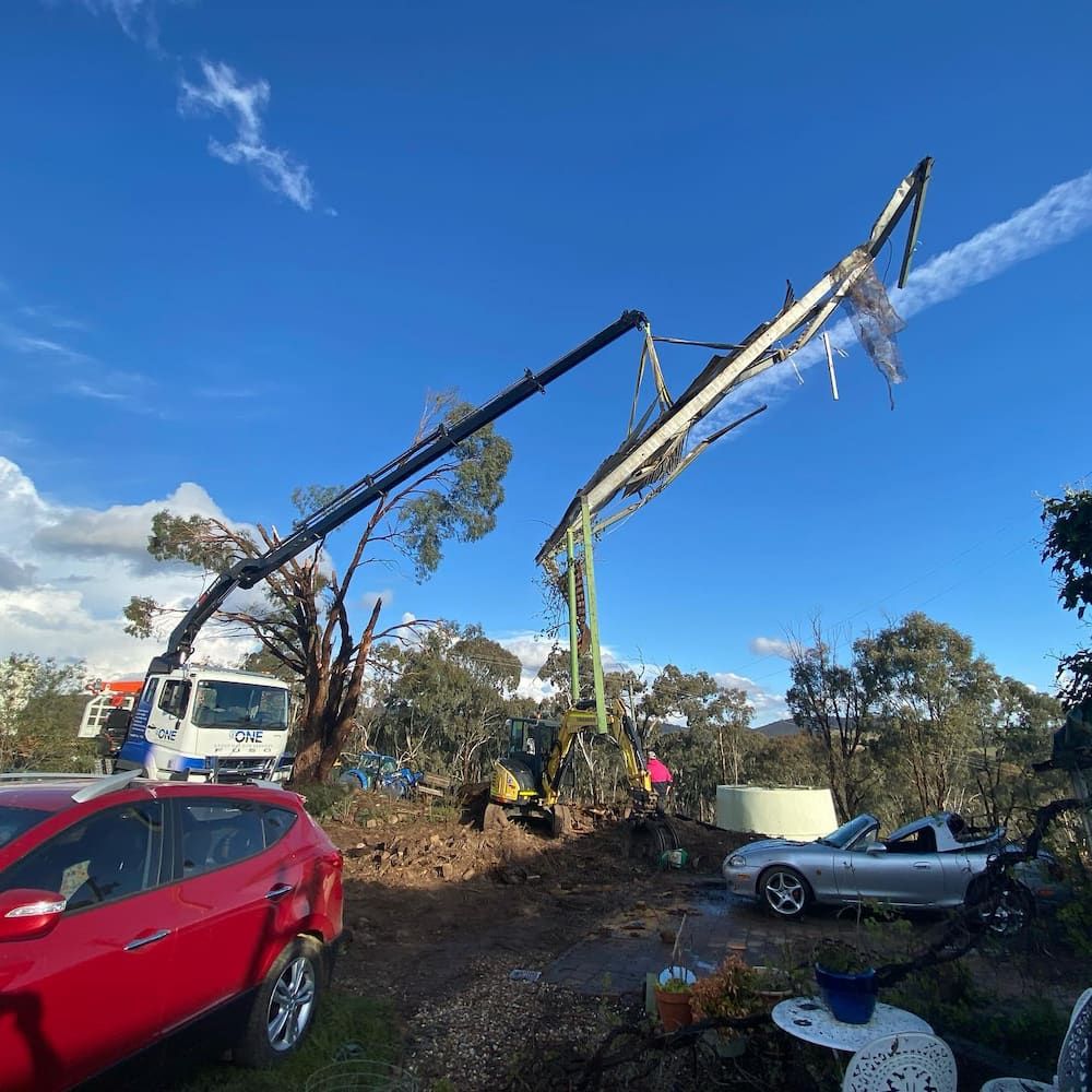 A Red Car is Parked in Front of a Crane — One Group Industries Pty Ltd in Bathurst, NSW