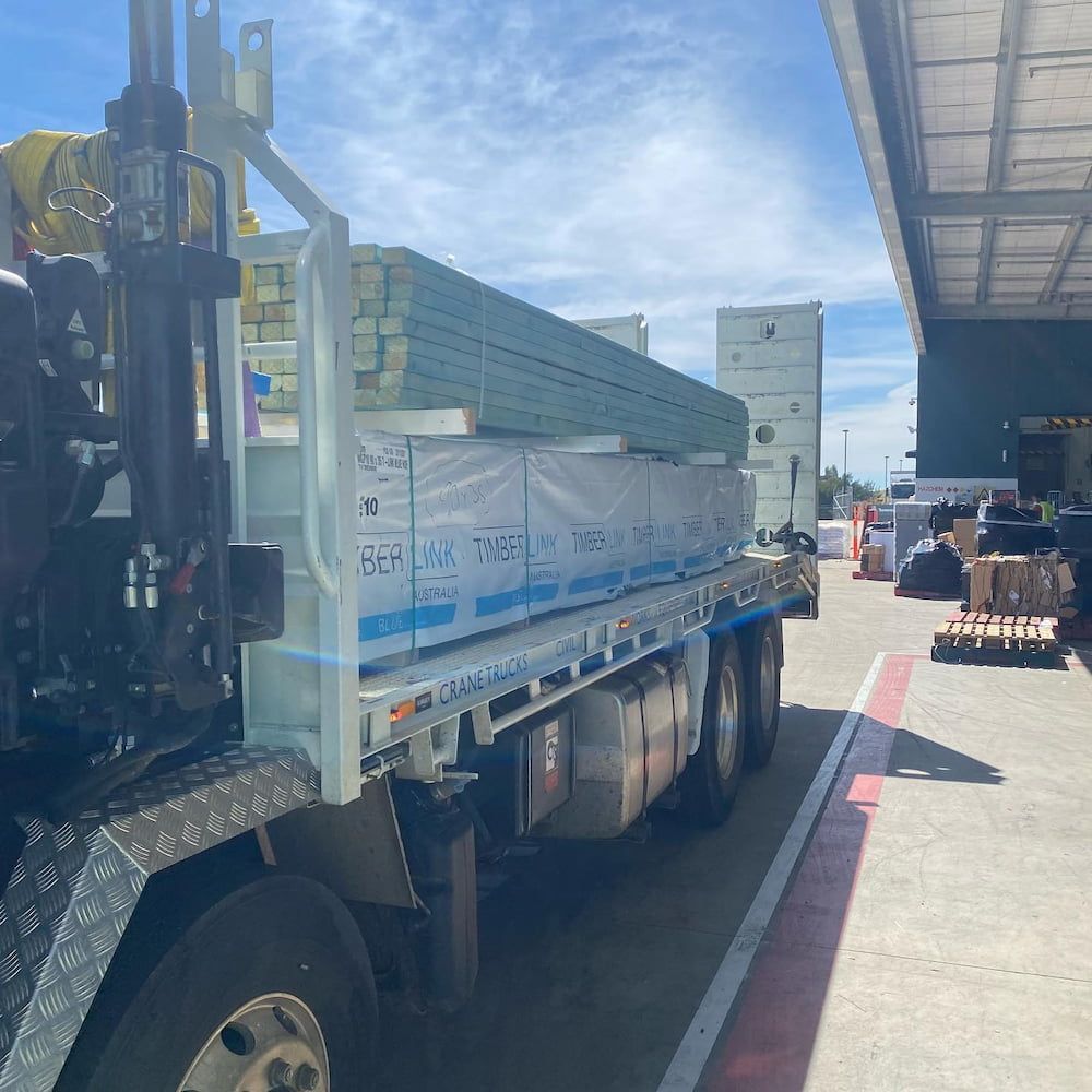 A Truck With a Forklift Attached to It is Parked in a Parking Lot — One Group Industries Pty Ltd in Bathurst, NSW