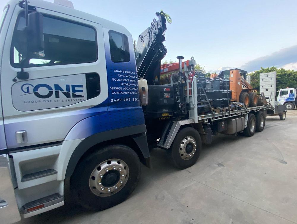 A Large Truck With a Crane on the Back is Parked in a Parking Lot — One Group Industries Pty Ltd in Bathurst, NSW