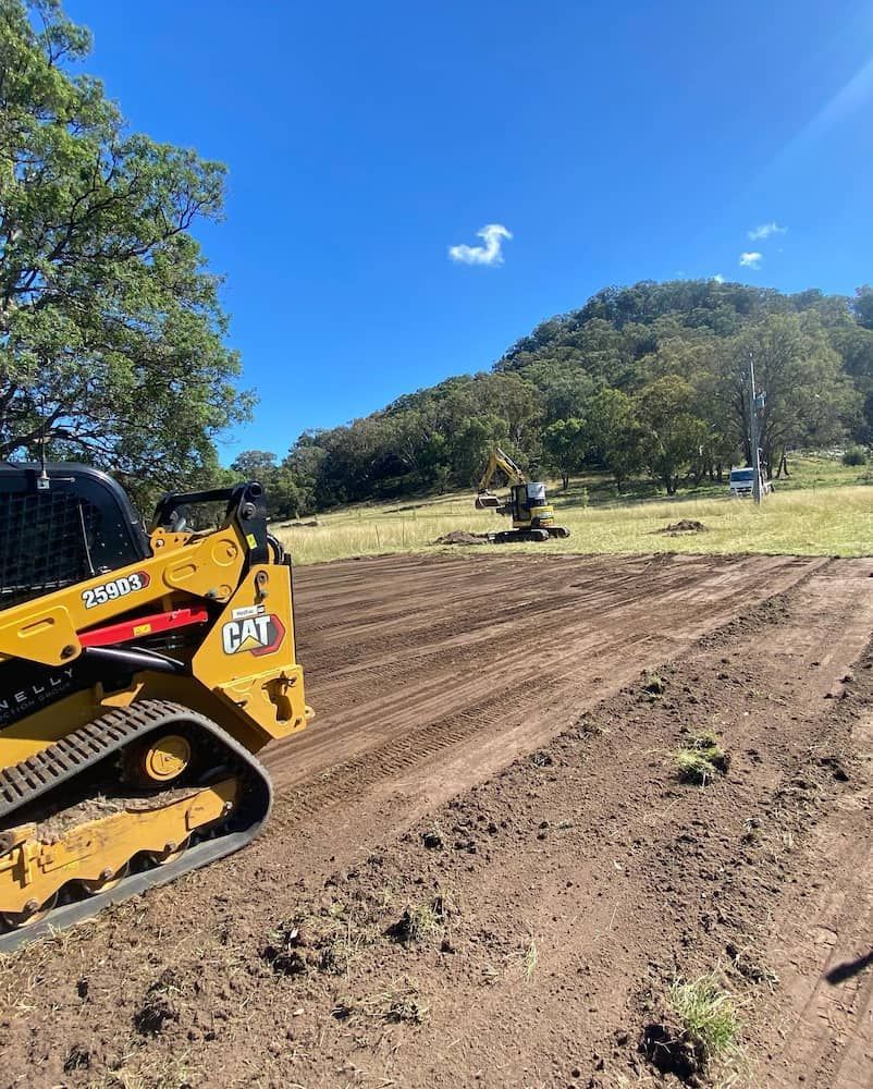 A Bulldozer is Sitting on Top of a Dirt Field — One Group Industries Pty Ltd in Bathurst, NSW