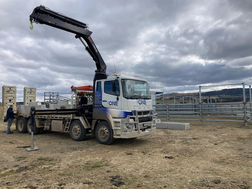 A Crane Truck is Parked in a Dirt Field — One Group Industries Pty Ltd in Bathurst, NSW