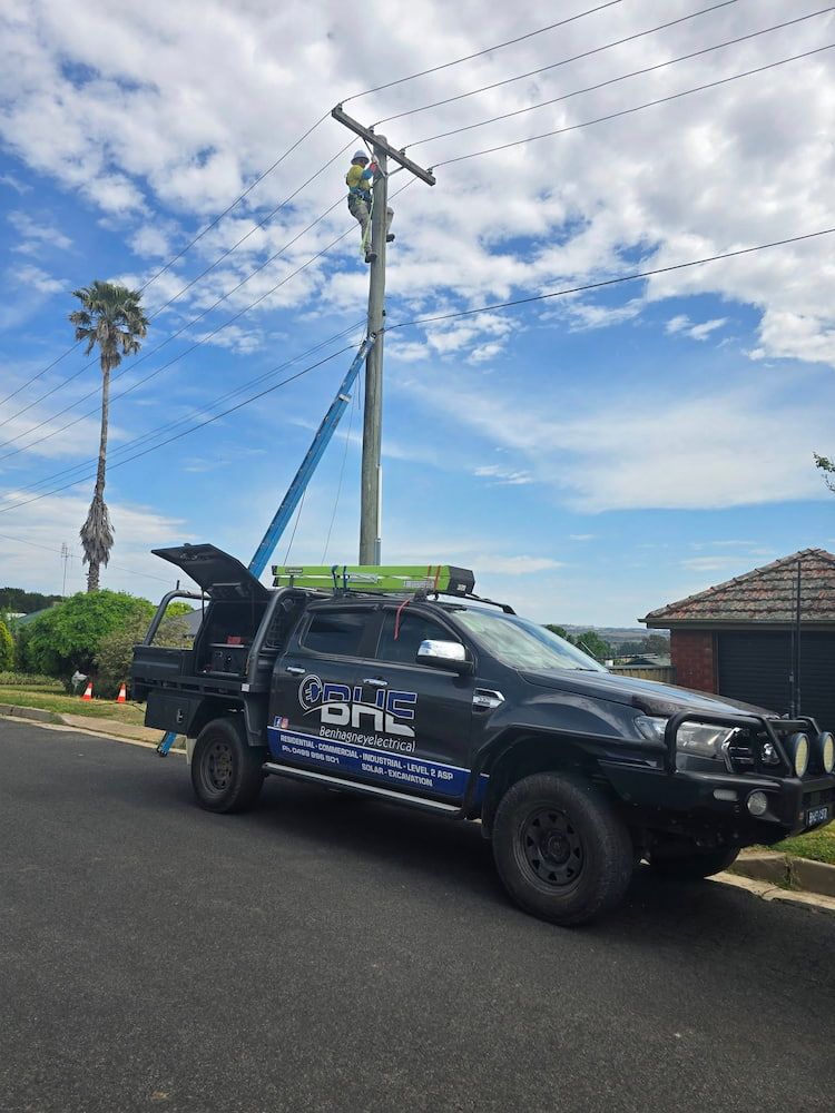 A Truck is Parked on the Side of the Road Next to a Power Pole — One Group Industries Pty Ltd in Bathurst, NSW