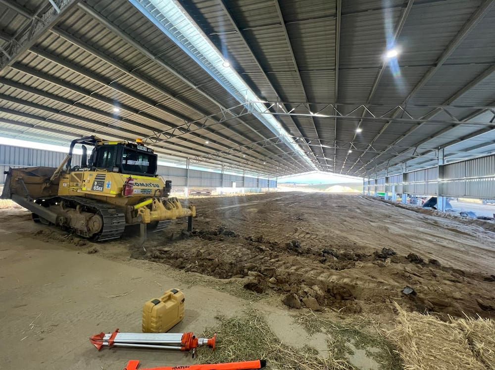A Bulldozer is Sitting in the Middle of a Large Building — One Group Industries Pty Ltd in Bathurst, NSW