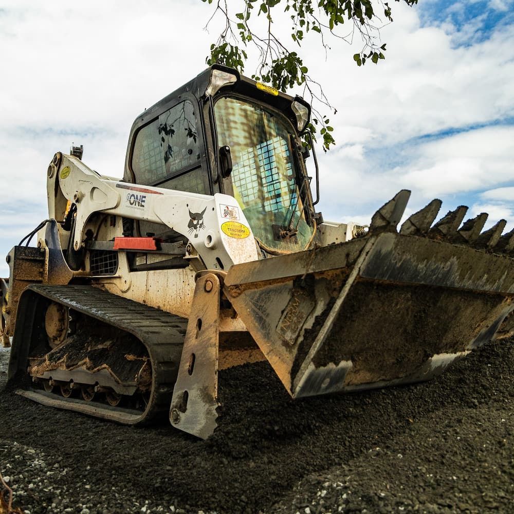 A Bobcat Bulldozer is Parked on a Gravel Road — One Group Industries Pty Ltd in Bathurst, NSW
