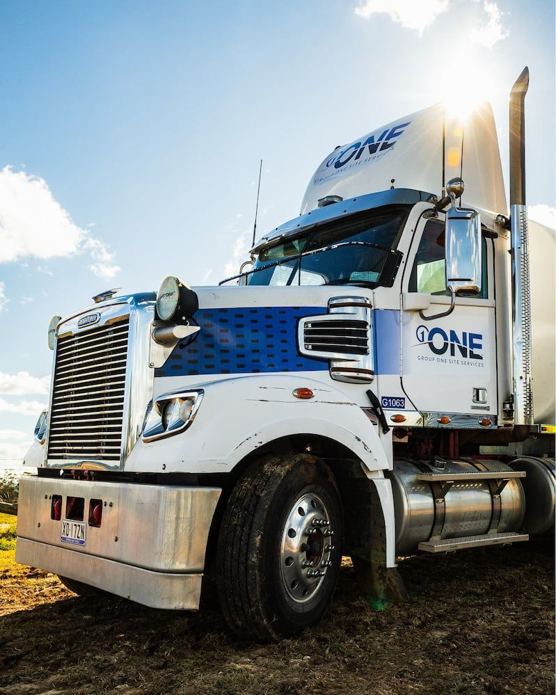 A White and Blue Semi Truck With the Word One — One Group Industries Pty Ltd in Bathurst, NSW
