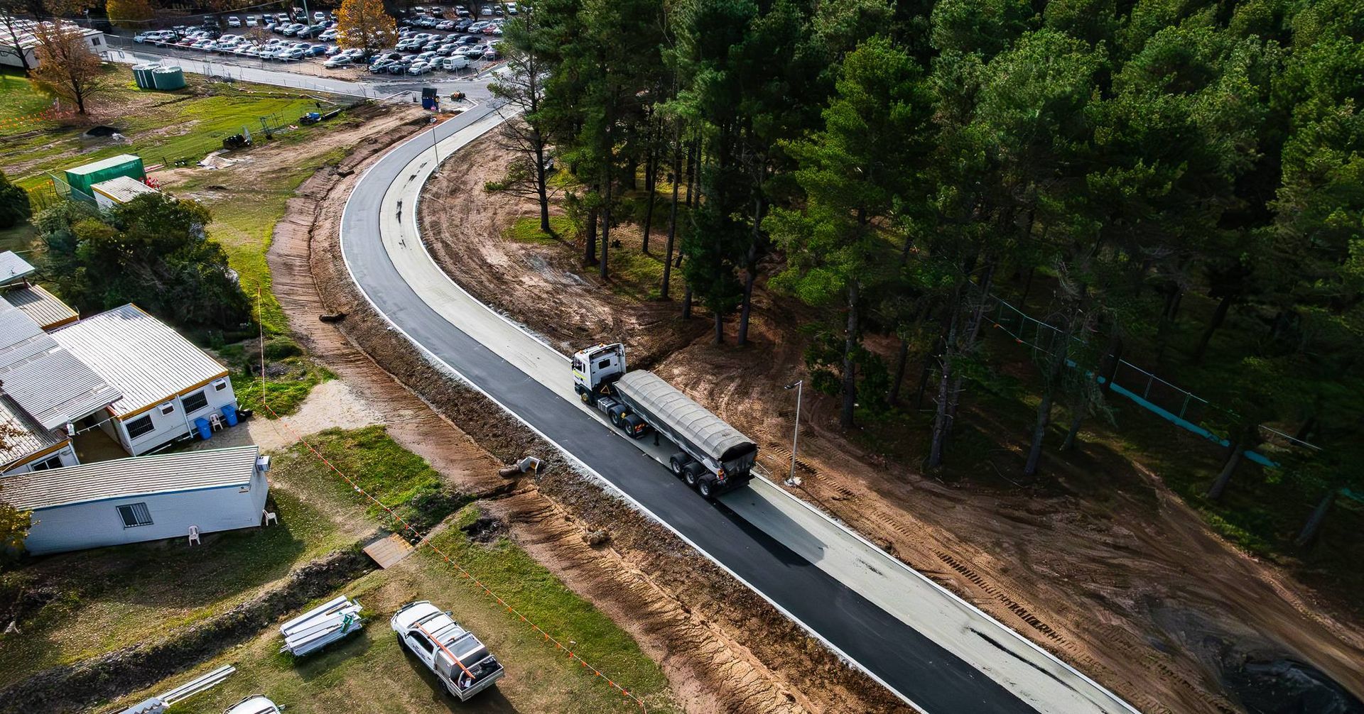 A Truck Travels Along a Newly Paved, Curving Road — One Group Industries Pty Ltd in Bathurst, NSW