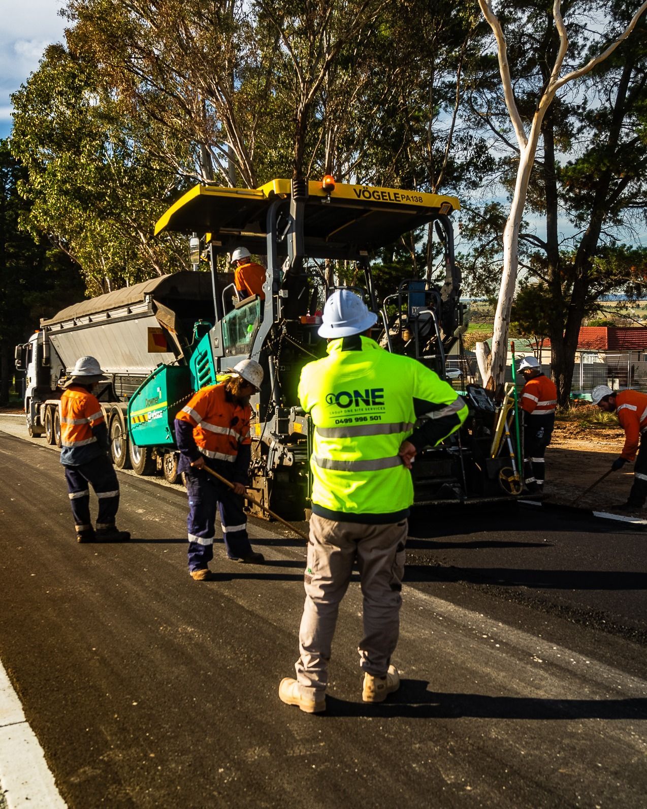 Workers in High-Visibility Clothing Operate an Asphalt Paver on A Road — One Group Industries Pty Ltd in Bathurst, NSW