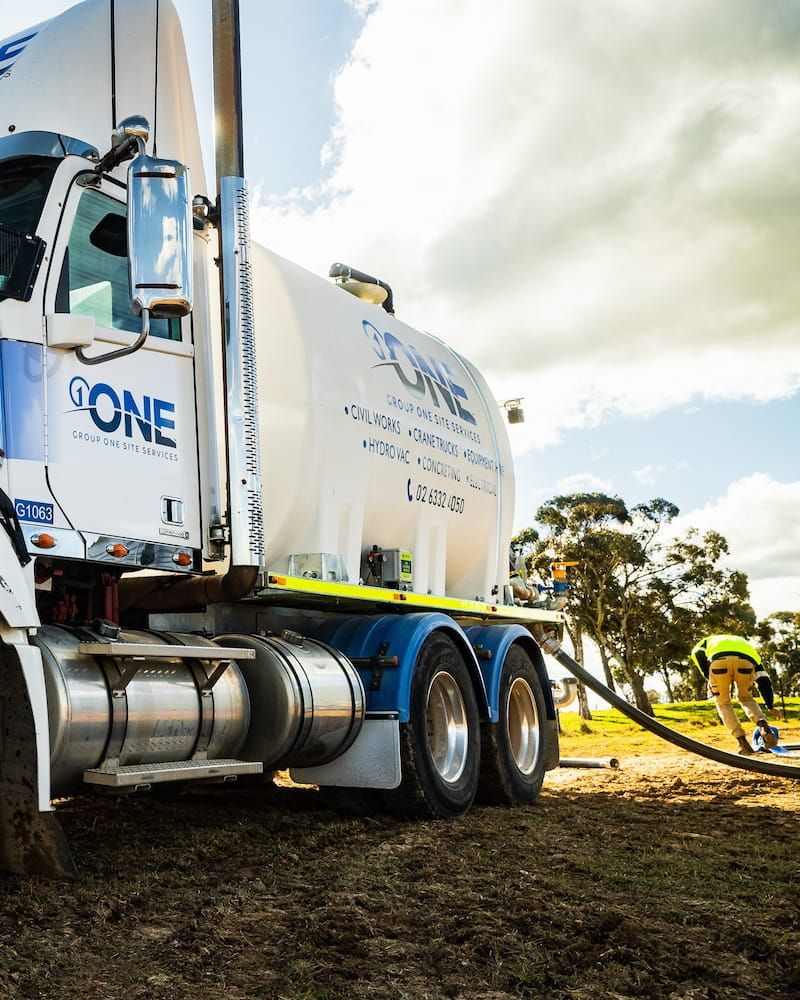 A Large White Truck With the Word Done on the Side is Parked in a Field — One Group Industries Pty Ltd in Bathurst, NSW