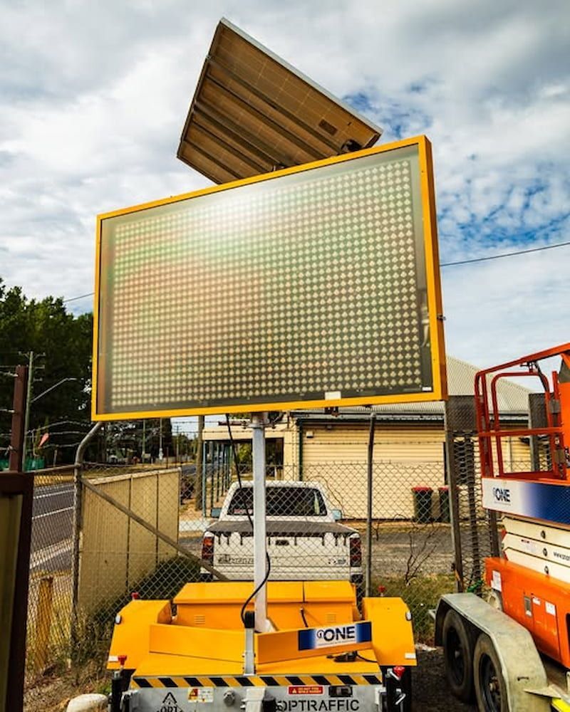A Large Yellow Sign is Sitting on Top of a Trailer — One Group Industries Pty Ltd in Bathurst, NSW