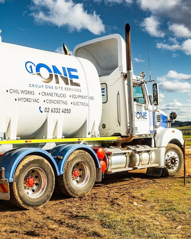 A White Truck With the Word Done on the Side is Parked in a Field — One Group Industries Pty Ltd in Bathurst, NSW