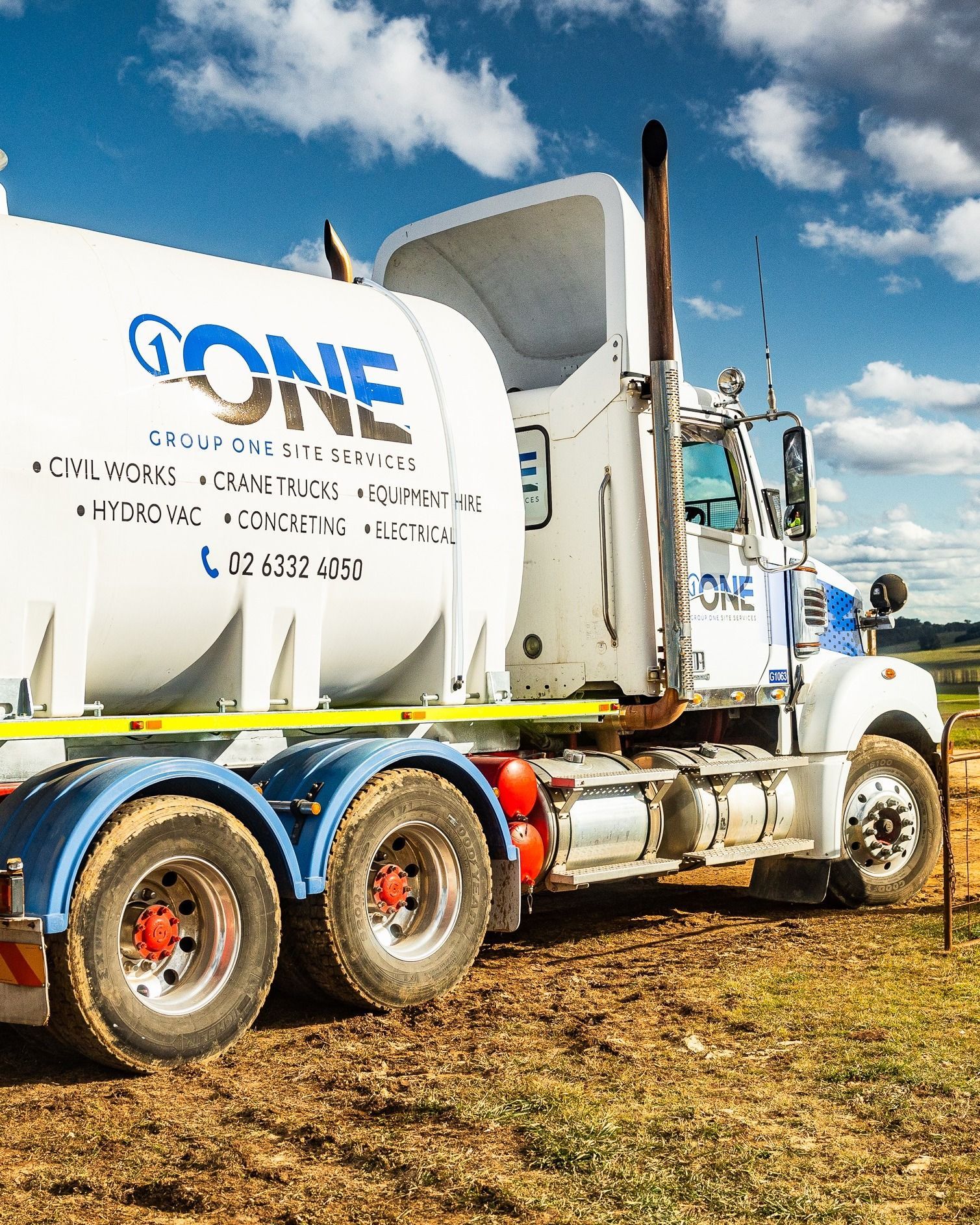 White  Services Truck Parked on A Dirt Lot Against a Blue, Cloudy Sky — One Group Industries Pty Ltd in Bathurst, NSW