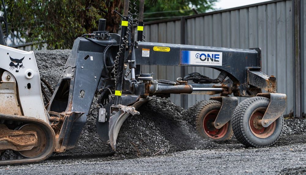 A Bulldozer is Moving Gravel on a Construction Site — One Group Industries Pty Ltd in Bathurst, NSW