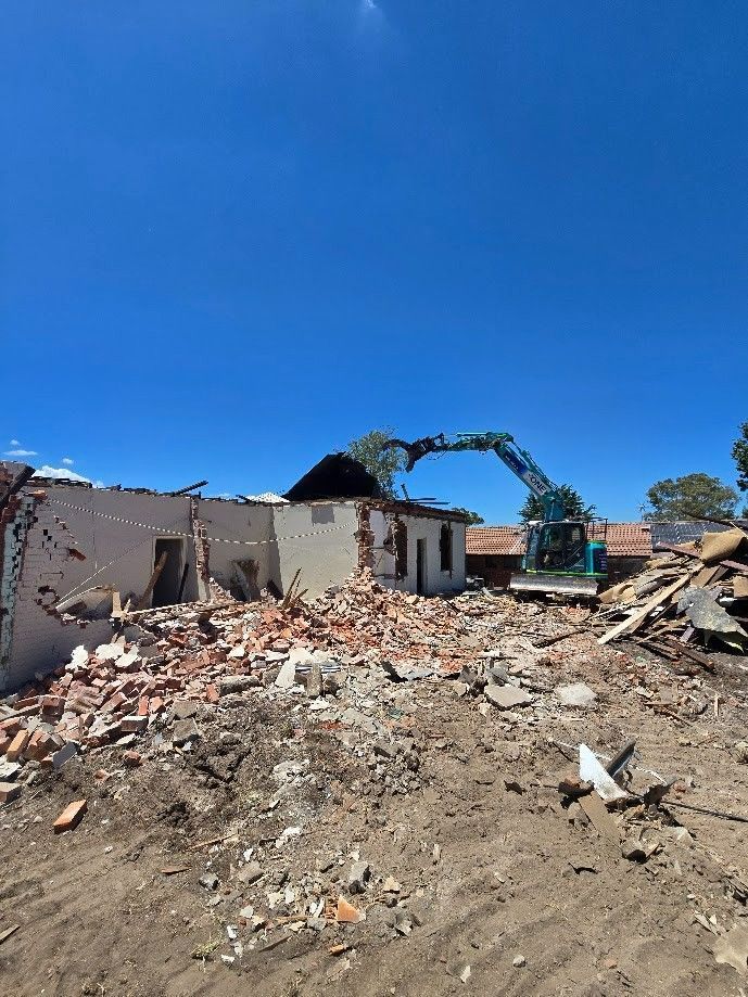 A Demolition Excavator Tears Down a Brick Building — One Group Industries Pty Ltd in Bathurst, NSW
