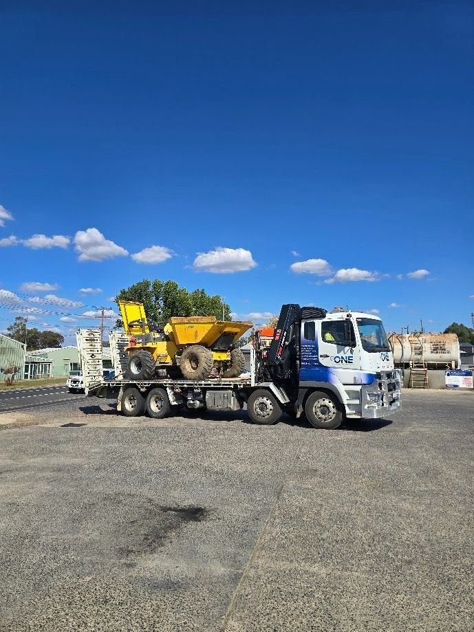 Truck Transporting Construction Equipment on A Sunny Day — One Group Industries Pty Ltd in Bathurst, NSW