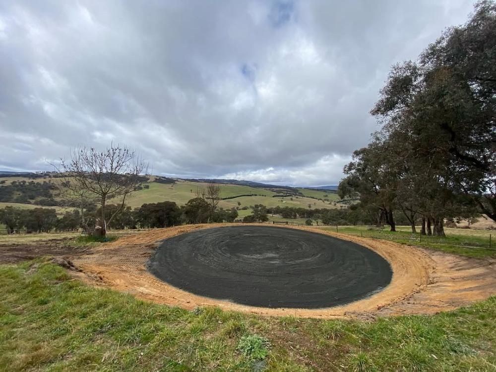A Large Circle in the Middle of a Grassy Field With Trees in the Background — One Group Industries Pty Ltd in Bathurst, NSW