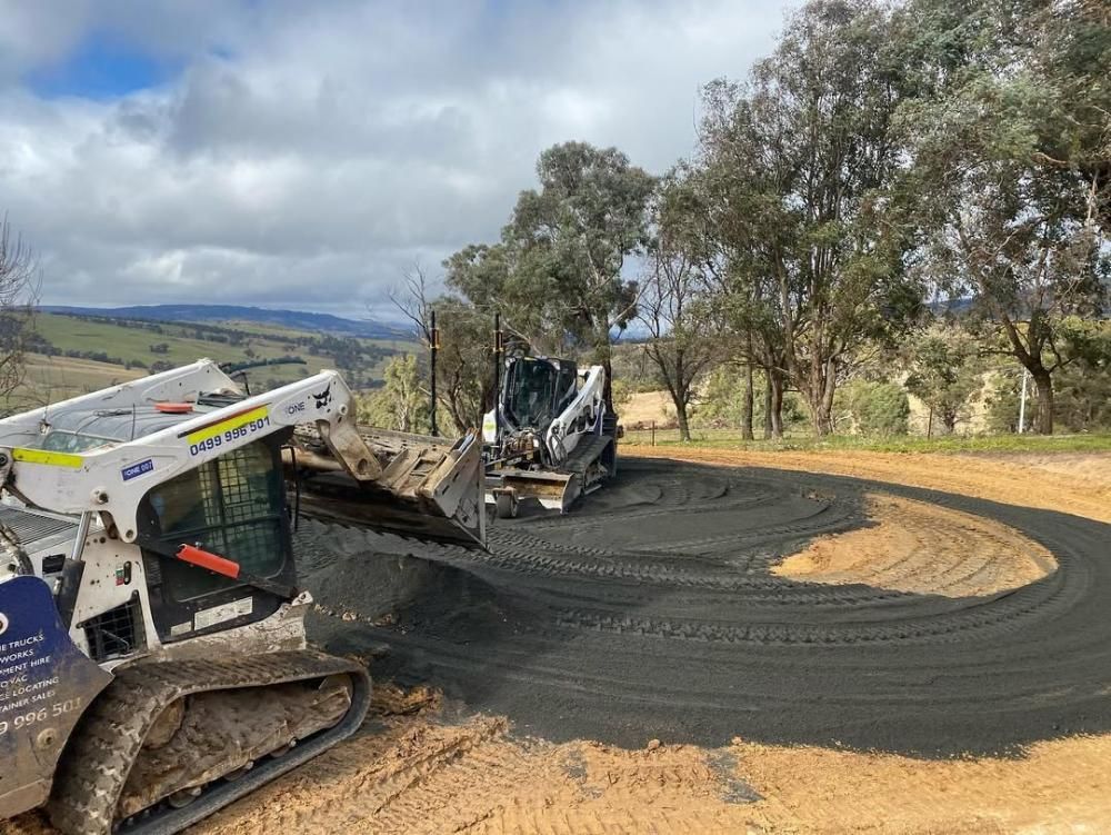 Two Bulldozers Are Working on a Dirt Road — One Group Industries Pty Ltd in Bathurst, NSW